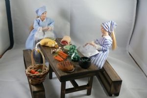 tudor table with food and kitchen maids